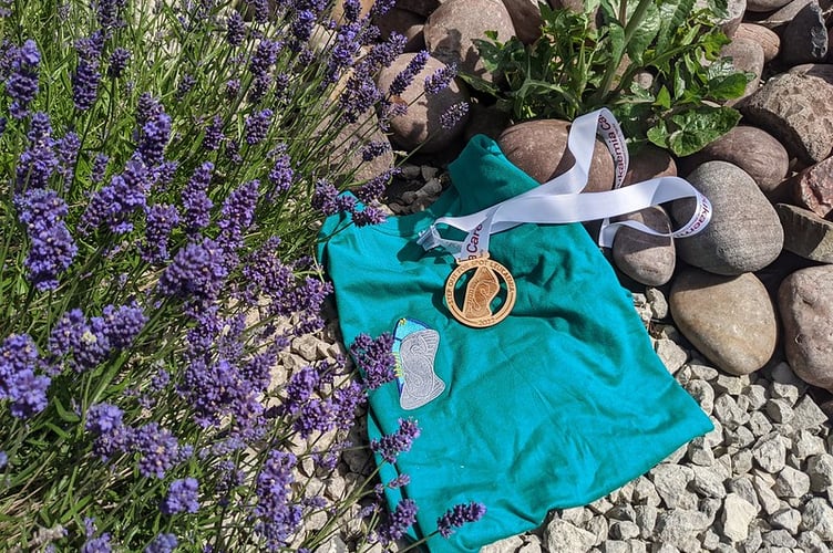 Leukaemia Care medal and t-shirt in garden setting with lavender