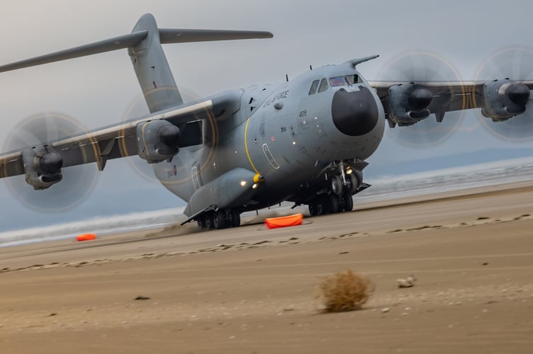 See SWNS story SWNAbeach. How's this for a day at the beach? Huge military transport planes have been spotted landing on Pembrey Sands in West Wales. The RAF Atlas A400Ms have been carrying out beach landing training at the coastal spot this week. They also practiced the insertion of so-called pathfinders, specialised soldiers dropped into place in order to set up and operate drop zones. Incredible pictures show the crews of the Brize Norton-based LXX and 30 Squadrons carrying out the objectives.