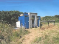 Former council leader helps toilet block stay at farm campsite